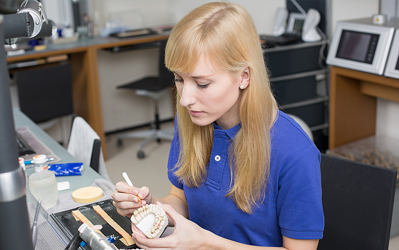 Dental Technician Making a Porcelain Crown making porcelain crowns nyc